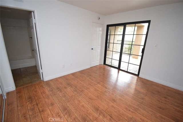 1052 Calle Del Cerro Unit 705, San Clemente, CA 92672 - unfurnished bedroom with hardwood / wood-style floors and baseboards