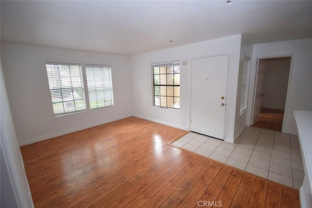 entryway featuring baseboards and light wood-style flooring