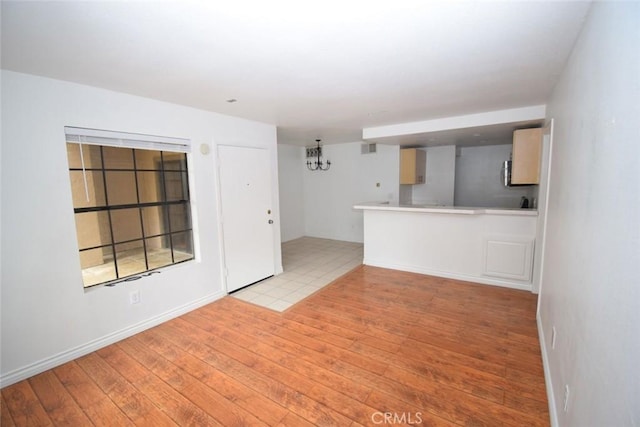 unfurnished living room with light wood-style flooring
