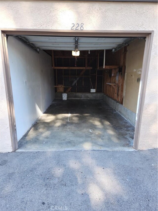 1052 Calle Del Cerro Unit 705, San Clemente, CA 92672 - garage with a garage door opener and driveway