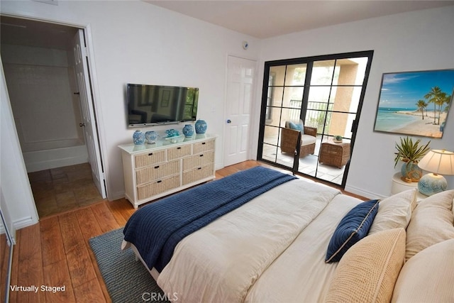 1052 Calle Del Cerro Unit 705, San Clemente, CA 92672 - bedroom with access to outside and hardwood / wood-style flooring