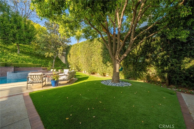 view of yard featuring an outdoor hangout area, a patio area, and an outdoor pool