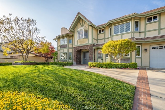 view of front of property featuring a chimney, concrete driveway, stucco siding, and a front yard