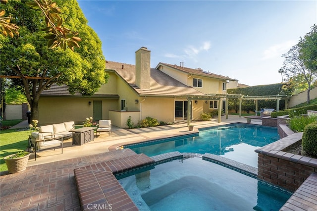 view of swimming pool with outdoor lounge area, a patio area, a pool with connected hot tub, and a pergola