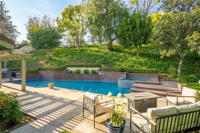 outdoor pool with a patio, outdoor lounge area, and an in ground hot tub