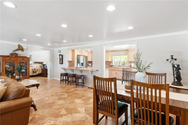 dining area featuring recessed lighting, ornamental molding, and baseboards