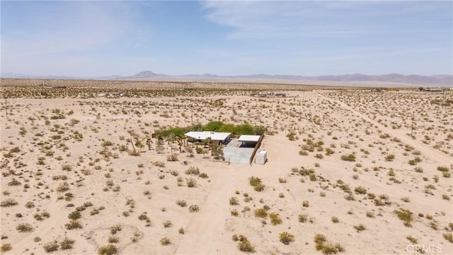aerial view featuring a rural view, a mountain view, and view of desert
