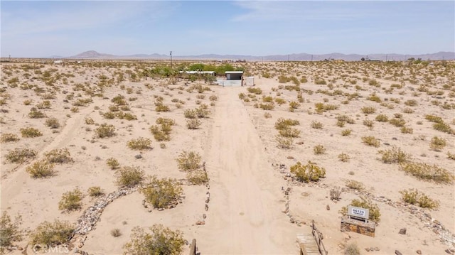 exterior space with a rural view, a mountain view, and a desert view