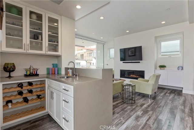 48 57th Pl, Long Beach, CA 90803 - kitchen featuring glass insert cabinets, dark wood-style floors, a healthy amount of sunlight, and a sink