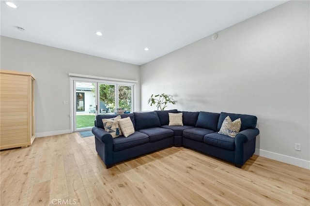 living room featuring light wood-style floors, baseboards, and recessed lighting