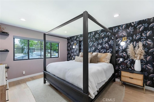 bedroom featuring wood finished floors, baseboards, and recessed lighting