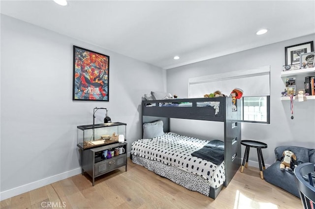 bedroom featuring wood finished floors, baseboards, and recessed lighting