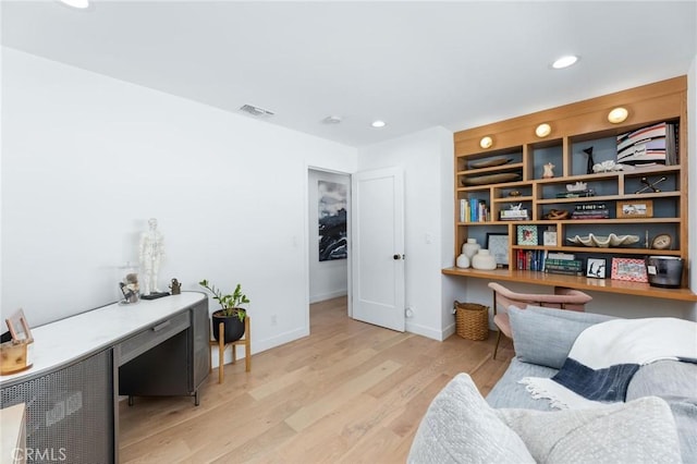 living area with baseboards, light wood-style flooring, recessed lighting, and built in study area