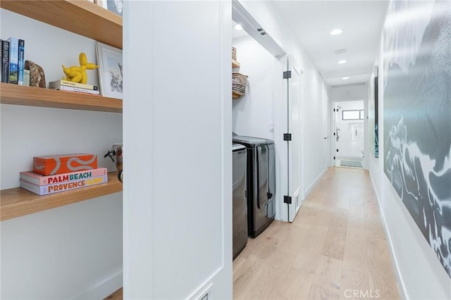 corridor with washing machine and clothes dryer, recessed lighting, and light wood-type flooring