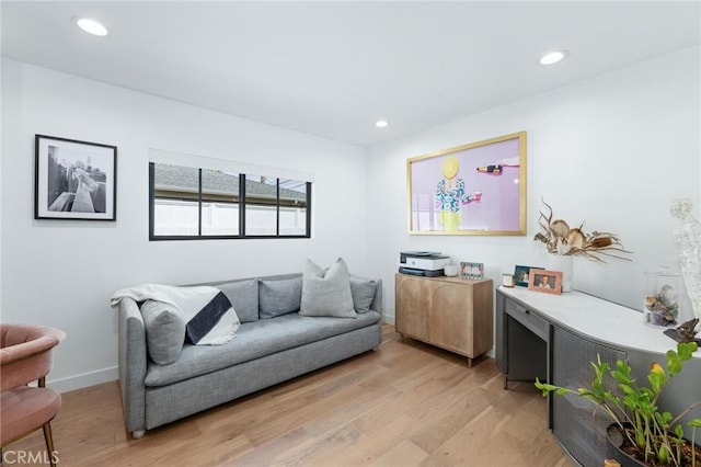 sitting room featuring light wood-style flooring, baseboards, and recessed lighting