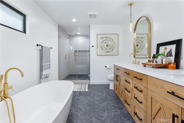 full bathroom with double vanity, toilet, a stall shower, a sink, and a freestanding tub