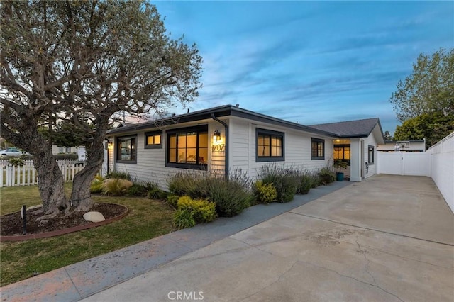 view of front of house with fence and driveway