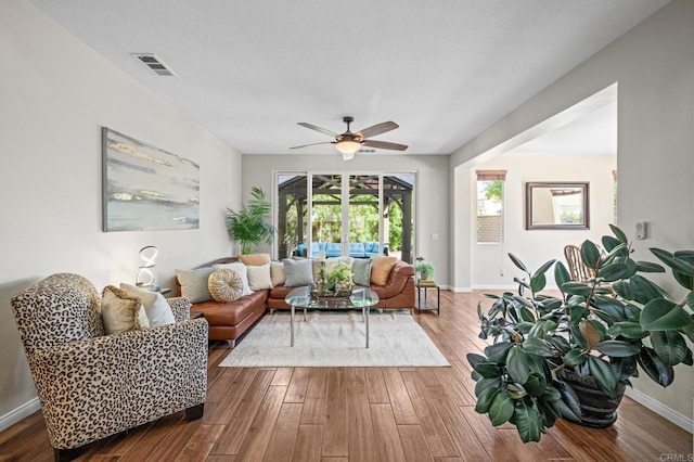 28829 Golden Dawn Dr, Menifee, CA 92584 - living area with baseboards, visible vents, ceiling fan, and hardwood / wood-style flooring