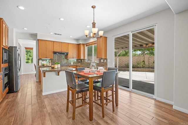 28829 Golden Dawn Dr, Menifee, CA 92584 - dining space featuring light wood-style floors, visible vents, recessed lighting, and a notable chandelier
