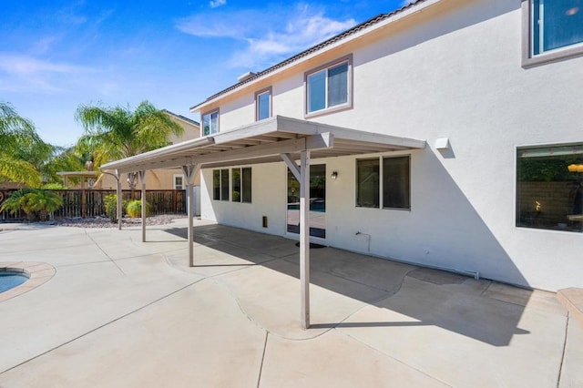 28829 Golden Dawn Dr, Menifee, CA 92584 - rear view of house featuring a patio, fence, and stucco siding