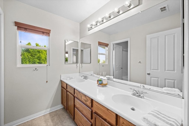 28829 Golden Dawn Dr, Menifee, CA 92584 - full bath with tile patterned flooring, visible vents, double vanity, baseboards, and a sink