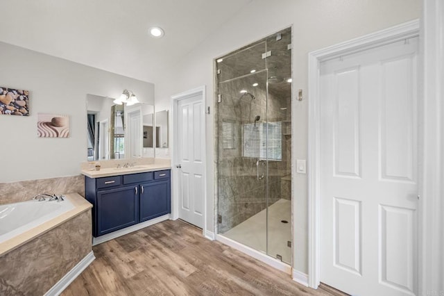 28829 Golden Dawn Dr, Menifee, CA 92584 - bathroom featuring vanity, a garden tub, wood finished floors, lofted ceiling, and a shower stall