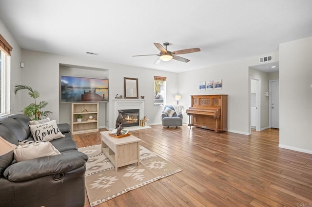 28829 Golden Dawn Dr, Menifee, CA 92584 - living room featuring a ceiling fan, visible vents, and wood finished floors