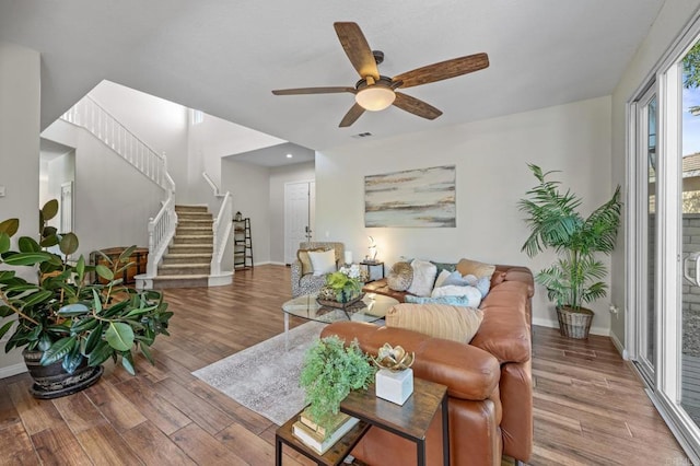 28829 Golden Dawn Dr, Menifee, CA 92584 - living room featuring baseboards, ceiling fan, wood finished floors, and stairway
