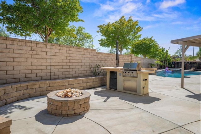 28829 Golden Dawn Dr, Menifee, CA 92584 - view of patio / terrace with grilling area, a fenced in pool, a fenced backyard, an outdoor kitchen, and a fire pit