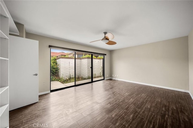 empty room featuring ceiling fan, baseboards, and wood finished floors