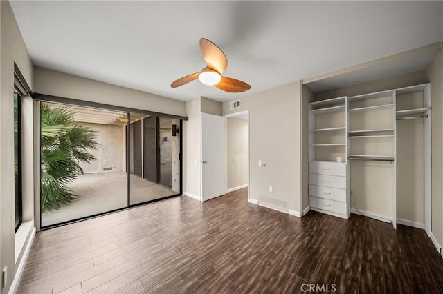 unfurnished bedroom featuring ceiling fan, baseboards, visible vents, and wood finished floors