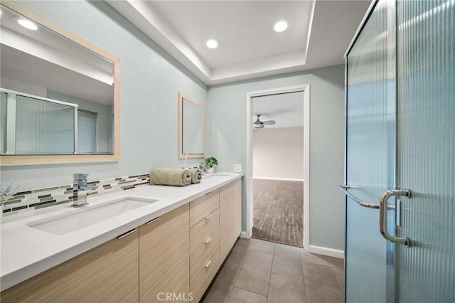 bathroom with a sink, recessed lighting, tile patterned flooring, double vanity, and baseboards