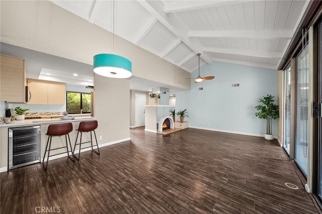 living room featuring beverage cooler, dark wood finished floors, baseboards, beamed ceiling, and ceiling fan