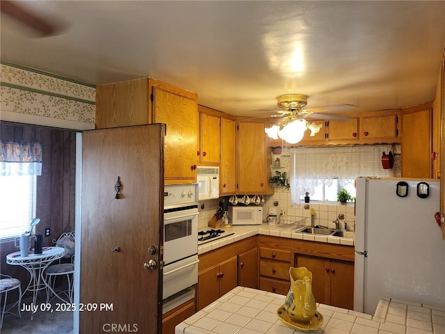 18340 Delicious St, Adelanto, CA 92301 - kitchen featuring white appliances, a warming drawer, tile countertops, ceiling fan, and brown cabinets