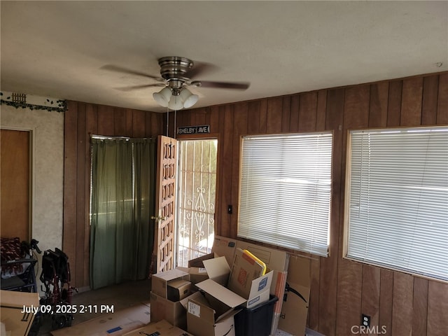 18340 Delicious St, Adelanto, CA 92301 - interior space featuring a ceiling fan, healthy amount of natural light, and wood walls