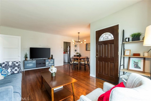 living area featuring an inviting chandelier and wood finished floors