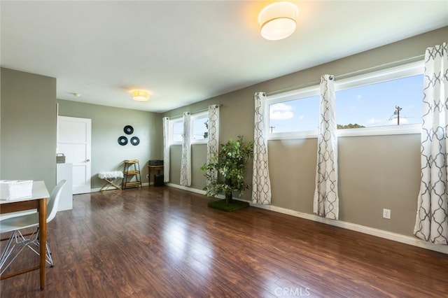 interior space with baseboards and wood finished floors
