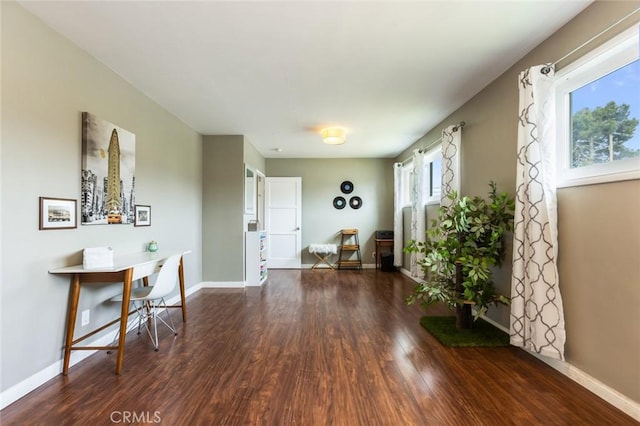 interior space with baseboards and wood finished floors