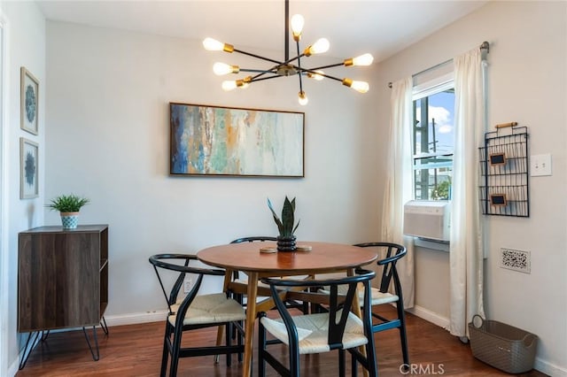 dining space featuring baseboards, a notable chandelier, and dark wood-style floors