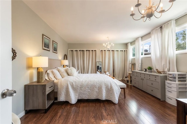 bedroom featuring dark wood-style floors and a chandelier