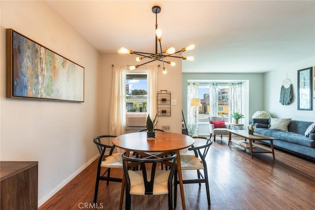 dining space with an inviting chandelier, baseboards, and wood finished floors