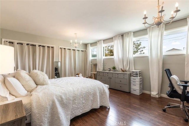 bedroom with baseboards, dark wood finished floors, and a notable chandelier