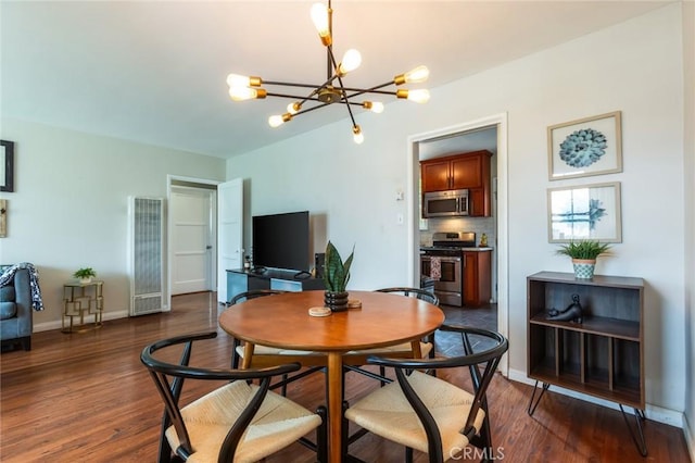 dining space featuring a heating unit, a notable chandelier, dark wood-style floors, and baseboards