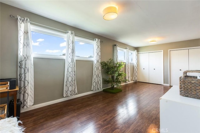 interior space featuring baseboards and wood finished floors