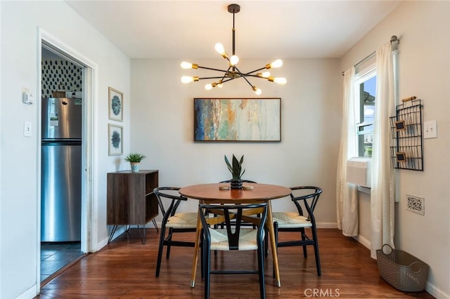 dining area with baseboards, an inviting chandelier, and dark wood-type flooring