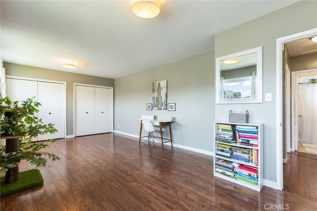 interior space with baseboards and wood finished floors