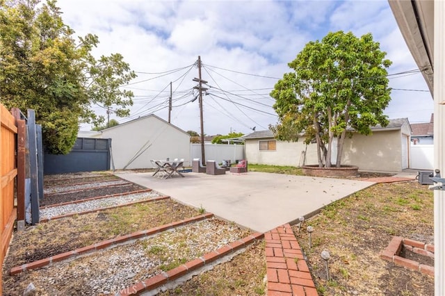 view of yard with a garden, a fenced backyard, and a patio area