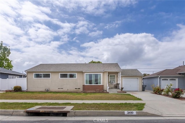 view of front of property with a garage, fence, a front yard, stucco siding, and driveway