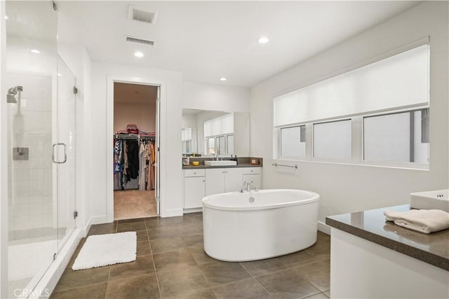 11818 N Hillsborough Ln, Porter Ranch, CA 91326 - full bathroom with a stall shower, vanity, a soaking tub, tile patterned floors, and a walk in closet