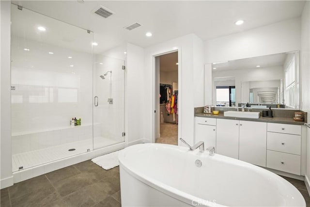 11818 N Hillsborough Ln, Porter Ranch, CA 91326 - bathroom featuring a freestanding tub, a stall shower, vanity, recessed lighting, and a walk in closet
